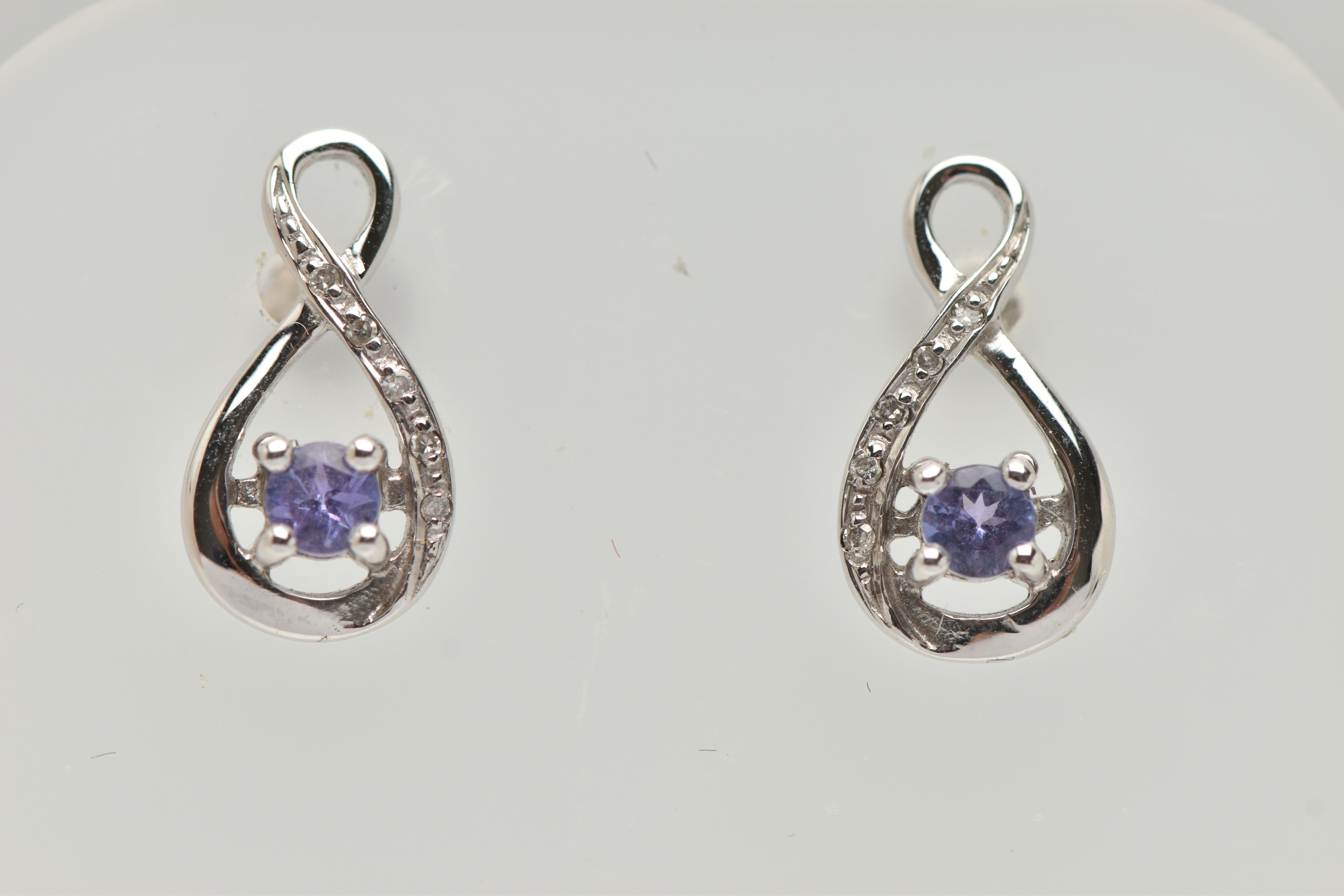 A BOXED PAIR OF 9CT WHITE GOLD TANZANITE AND DIAMOND SET EARRINGS, each earring set with a small - Image 2 of 3