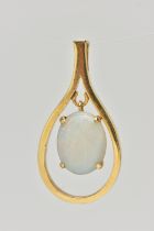 A YELLOW METAL OPAL CABCOHON PENDANT, open work tear drop shape pendant, set with a central oval cut