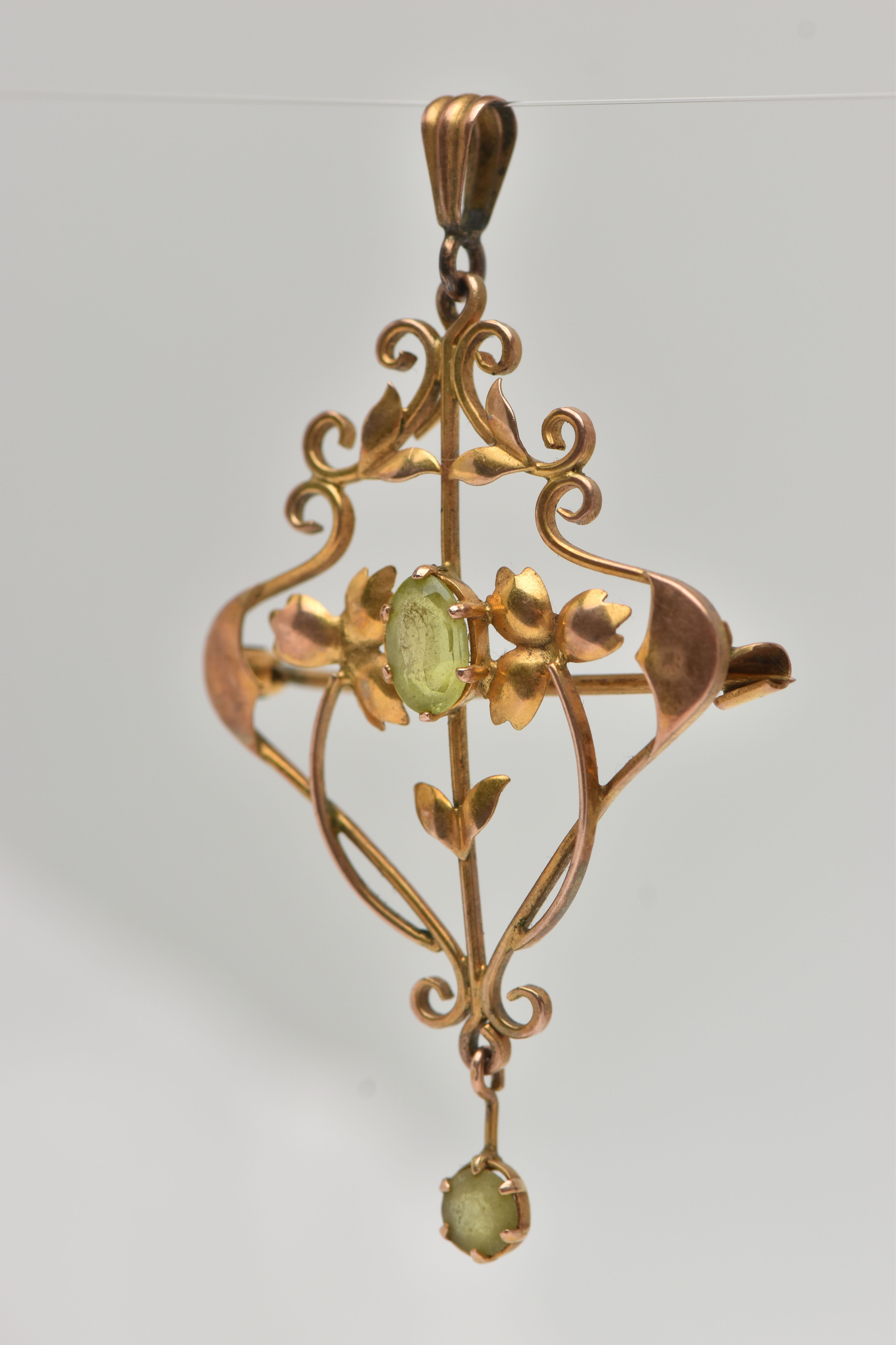 A YELLOW METAL PERIDOT SET LAVALIER PENDANT, open work floral pattern, set with a central oval cut - Image 2 of 3