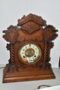 A AMERICAN MANTEL CLOCK, made by The Ansonia Clock Company - New York, a stained pine gingerbread