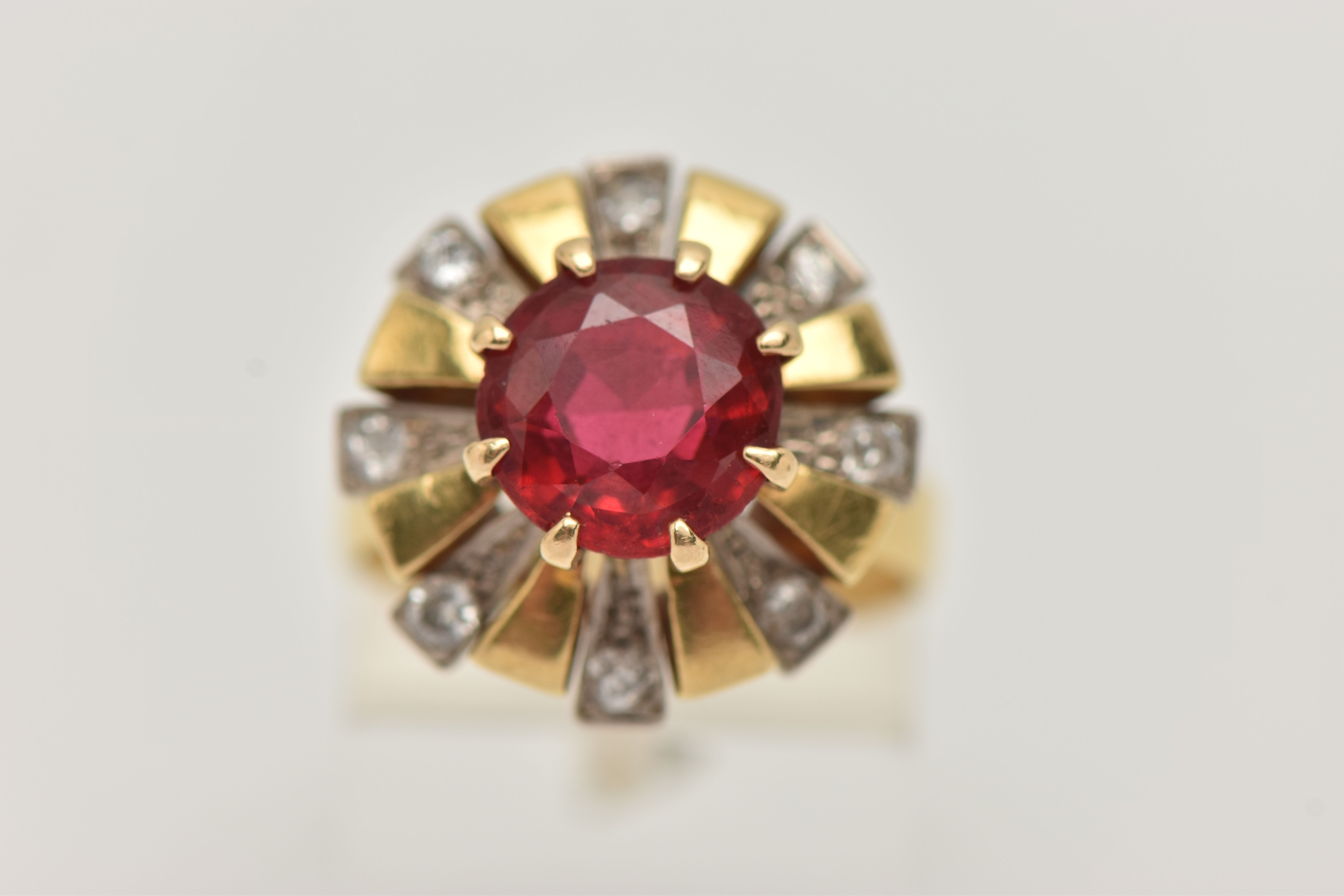 A YELLOW METAL GEM SET DRESS RING, centering on a large circular cut garnet topped red paste - Image 5 of 5