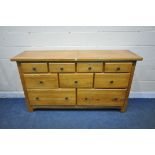 A HEAVY SOLID OAK SIDEBOARD, fitted with an arrangement of nine drawers, length 180cm x depth 51cm x