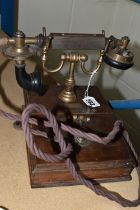 AN EARLY 20TH CENTURY 'THE MAGNET' TELEPHONE, on a wooden base, height 20cm (Condition Report: in