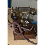 AN EARLY 20TH CENTURY 'THE MAGNET' TELEPHONE, on a wooden base, height 20cm (Condition Report: in