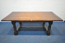 A GOOD QUALITY ROYAL OAK 7FT OAK REFECTORY TABLE, raised on block and turned legs, united by a H