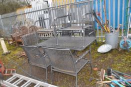 A MODERN STEEL GARDEN TABLE with six matching chair and cushions ( stored inside) table width