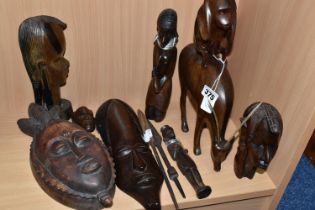 A GROUP OF CARVED HARDWOOD TRIBAL FIGURES, comprising ten carved wooden souvenir figures of animals,