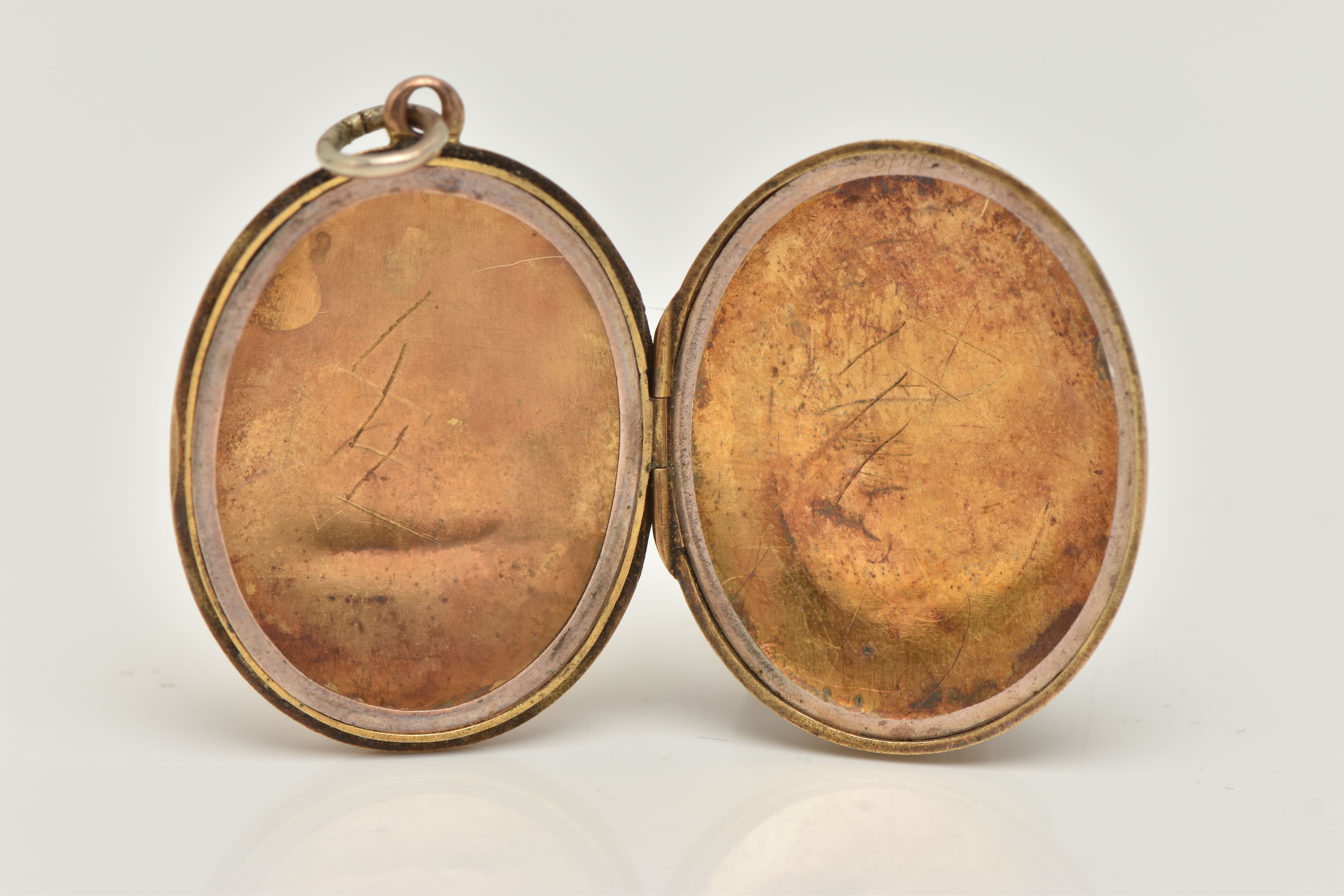 A YELLOW METAL OVAL LOCKET PENDANT, floral and foliate pattern with vacant cartouche, opens to - Image 2 of 2