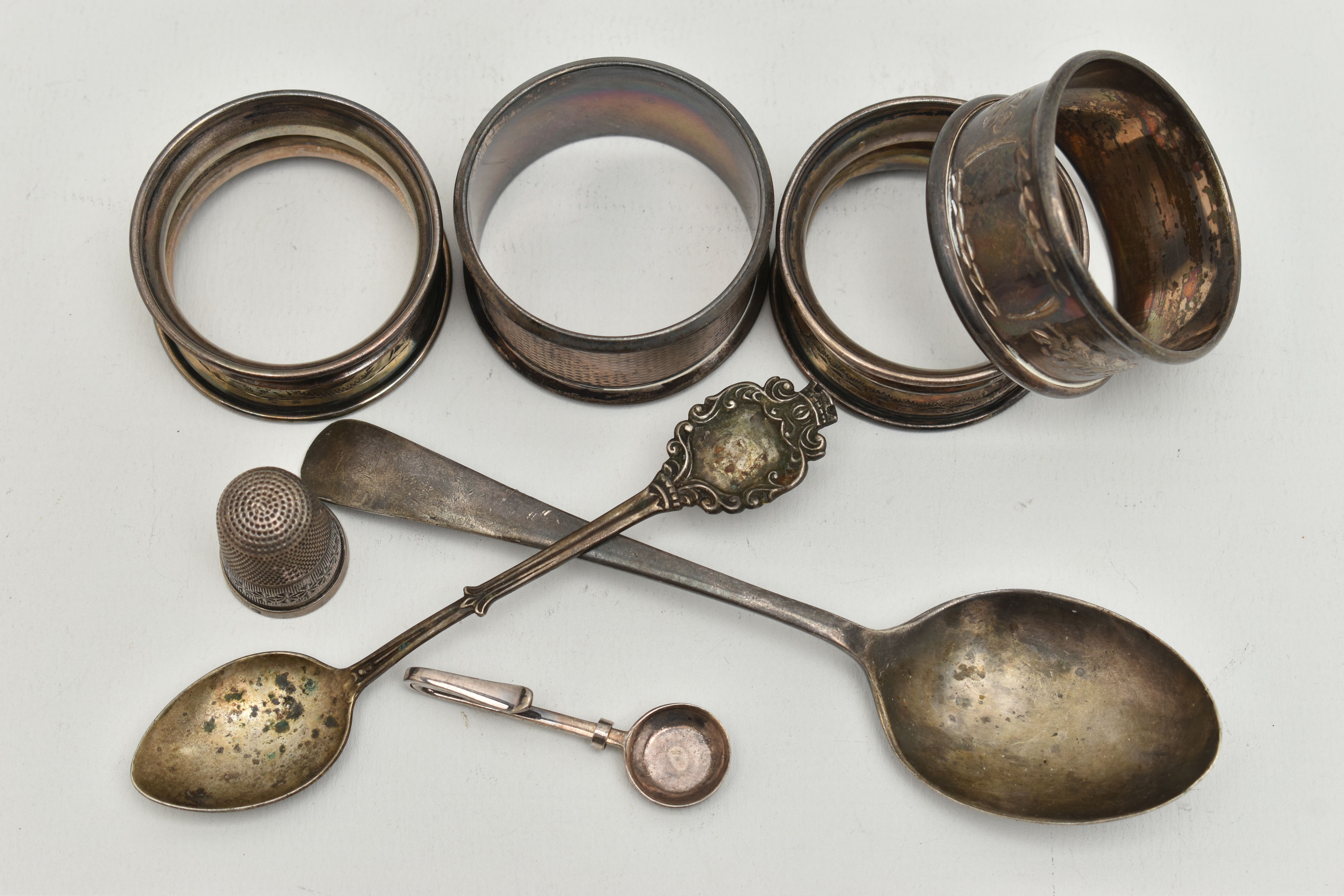 AN ASSORTMENT OF SILVER ITEMS, to include four silver napkin rings, a tea spoon, a spoon a thimble - Image 2 of 3