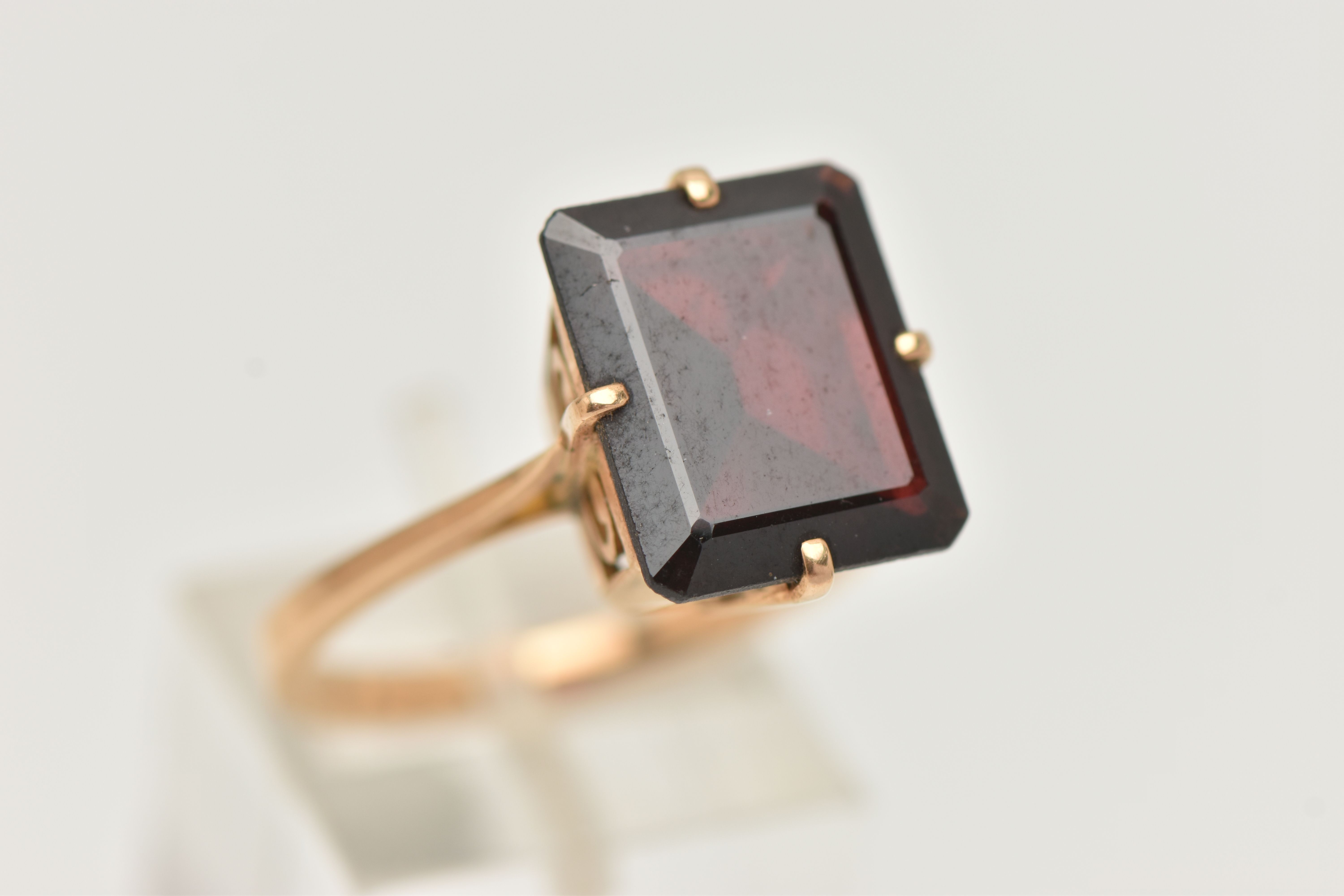 A GARNET DRESS RING, a large rectangular cut garnet, approximate length 13mm x width 11mm, four - Image 4 of 4