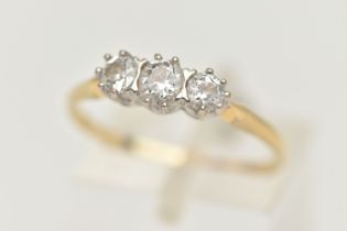 A YELLOW METAL THREE STONE DIAMOND RING, three round brilliant cut diamonds, each claw set,