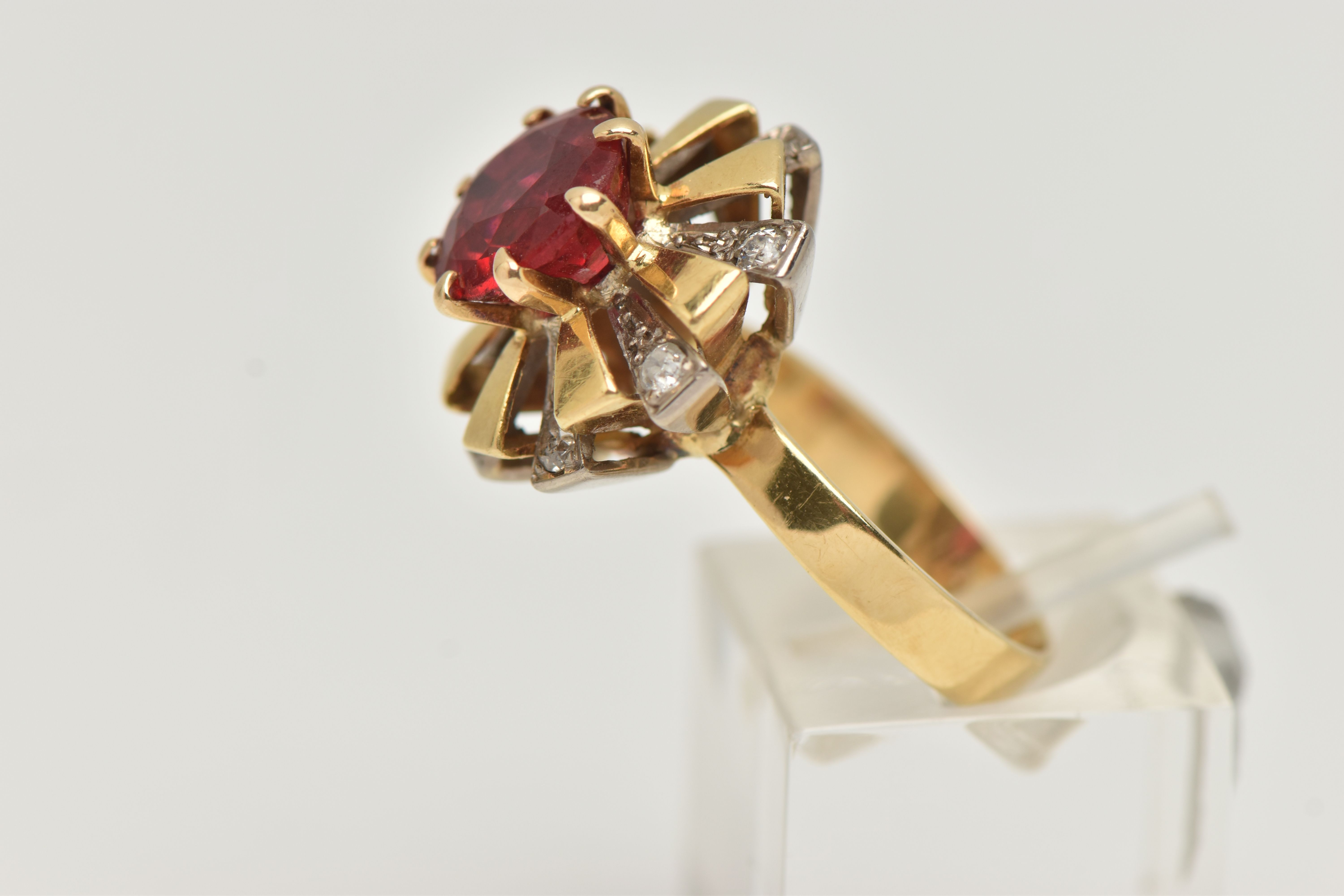 A YELLOW METAL GEM SET DRESS RING, centering on a large circular cut garnet topped red paste - Image 2 of 5