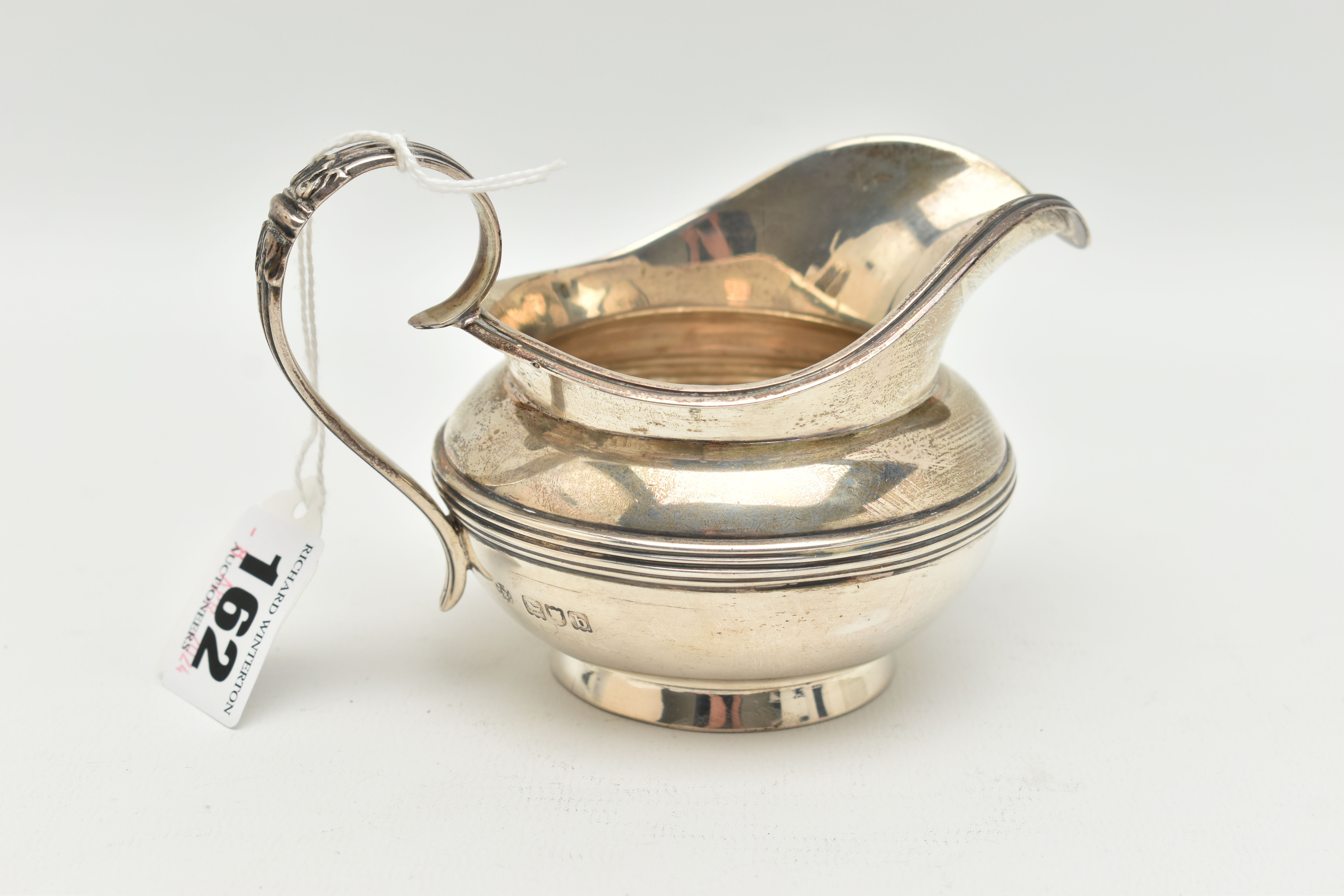 A LATE VICTORIAN CREAM JUG, baluster silver cream jug with acanthus detail to the scrolled handle,