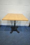 A WERZALIT OAK EFFECT SQUARE TOP TABLE, raised on a cast iron base, 70cm squared x height 74cm (