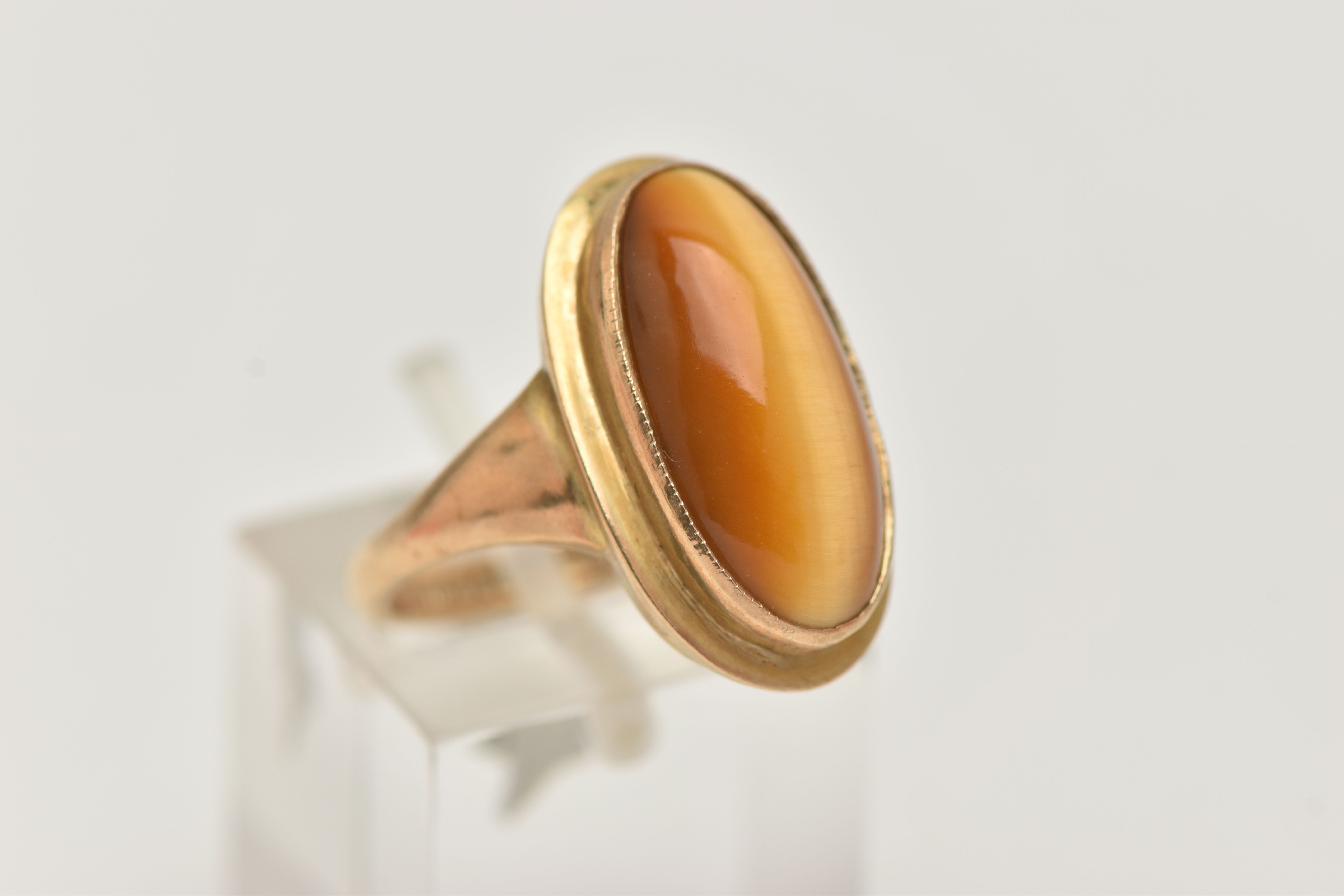 A 9CT GOLD DRESS RING, an elongated oval cabochon tigers eye, collet set in yellow gold, leading - Image 4 of 5