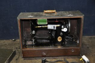 A CASED SINGER ELECTRIC SEWING MACHINE with green alligator skin effect covering to case (UNTESTED)