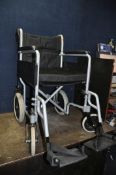 AN ANGEL MOBILITY FOLDING WHEEL CHAIR with seat pad and two footrests