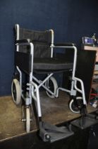 AN ANGEL MOBILITY FOLDING WHEEL CHAIR with seat pad and two footrests