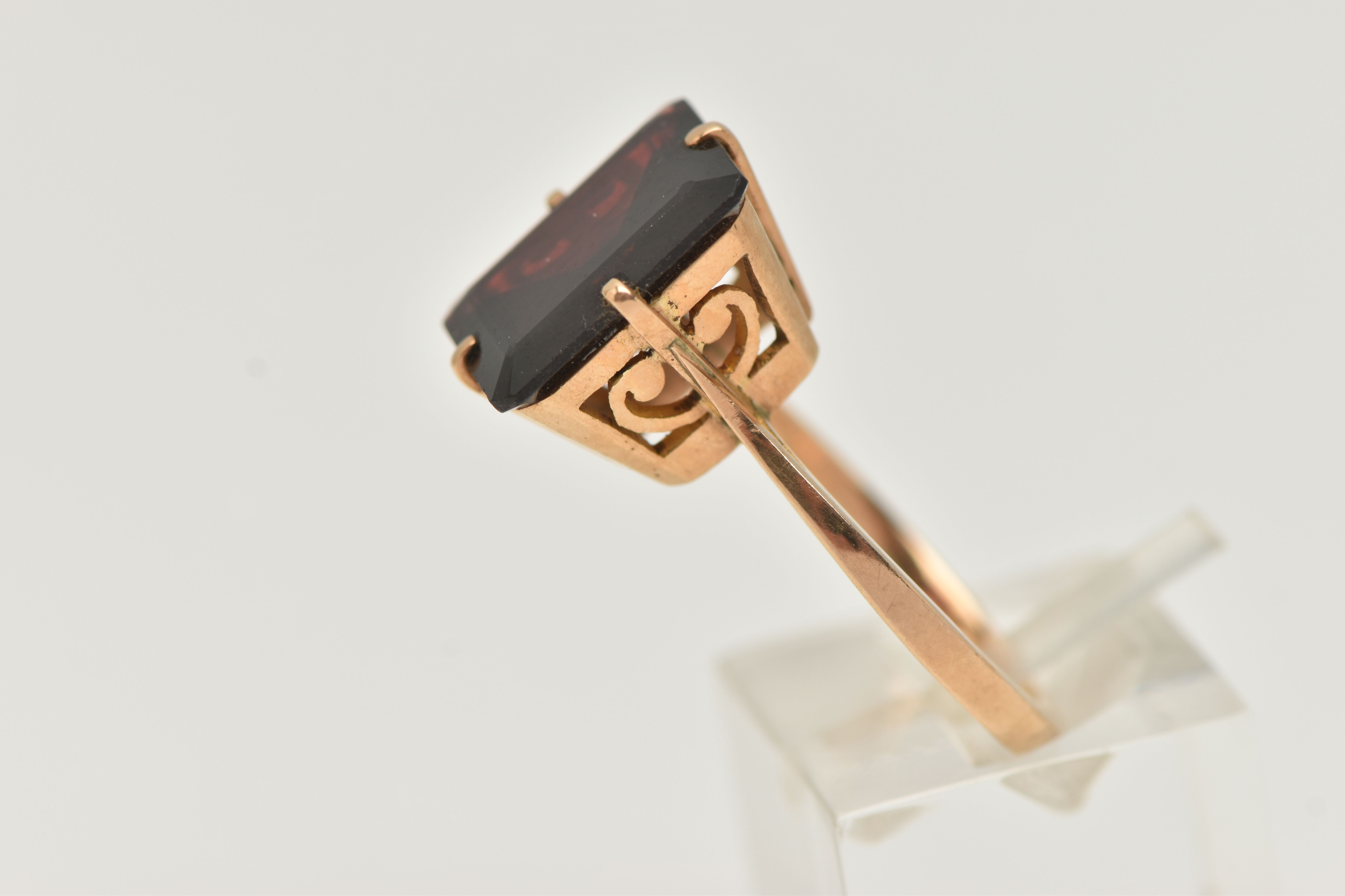 A GARNET DRESS RING, a large rectangular cut garnet, approximate length 13mm x width 11mm, four - Image 2 of 4