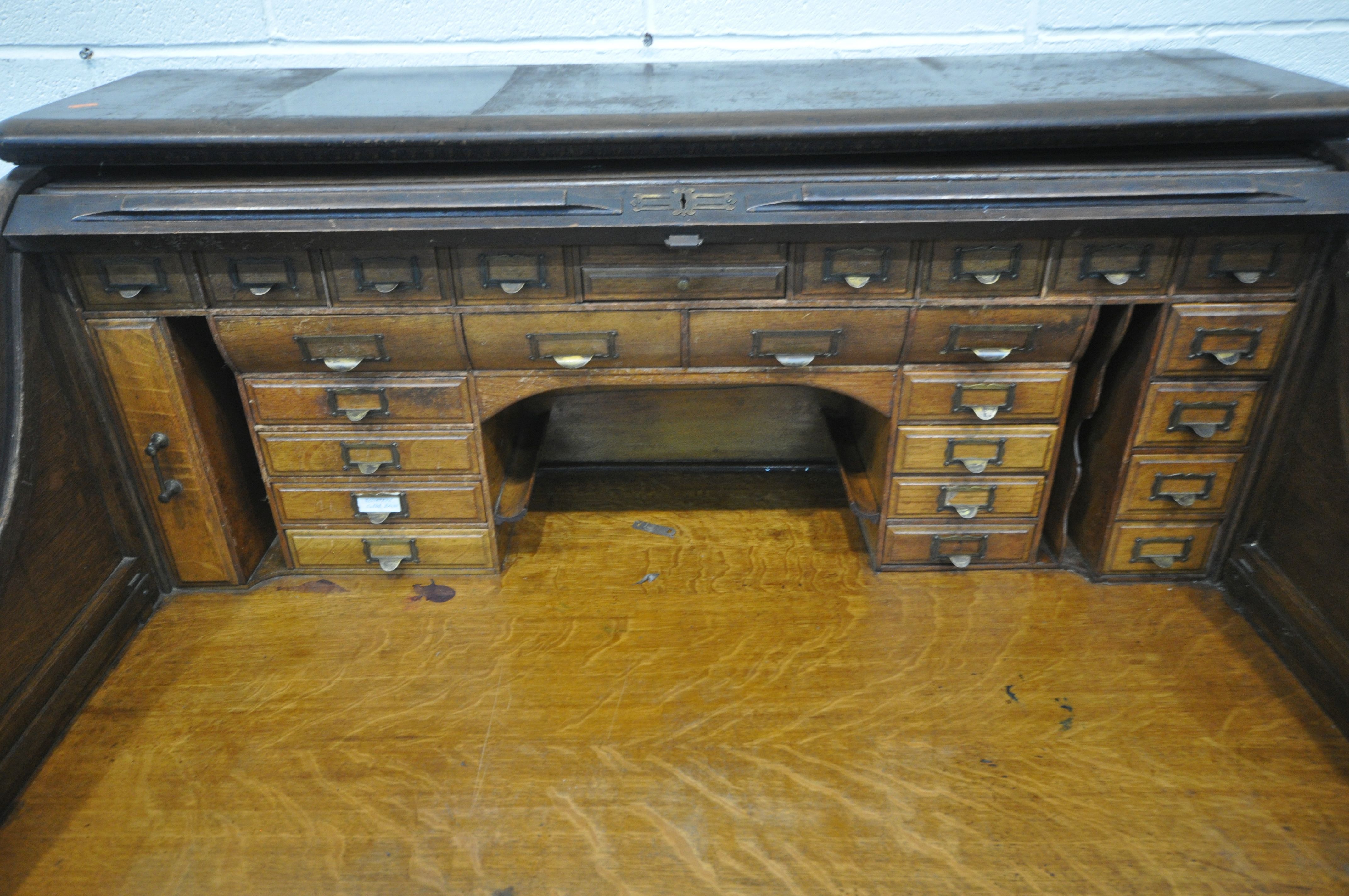 AN EARLY 20TH CENTURY OAK ROLL TOP DESK, enclosing a fitted interior, on two pedestals, each with - Image 4 of 8