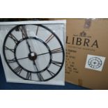 A BOXED 'LIBRA' UNUSED WALL CLOCK, a black and bronze coloured metal wall clock with Roman numerals,