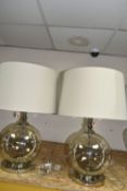 TWO MODERN TABLE LAMPS, with glass bodies and wheat coloured shades, height to top of fitting