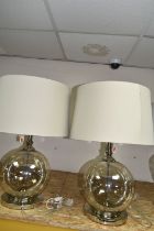 TWO MODERN TABLE LAMPS, with glass bodies and wheat coloured shades, height to top of fitting