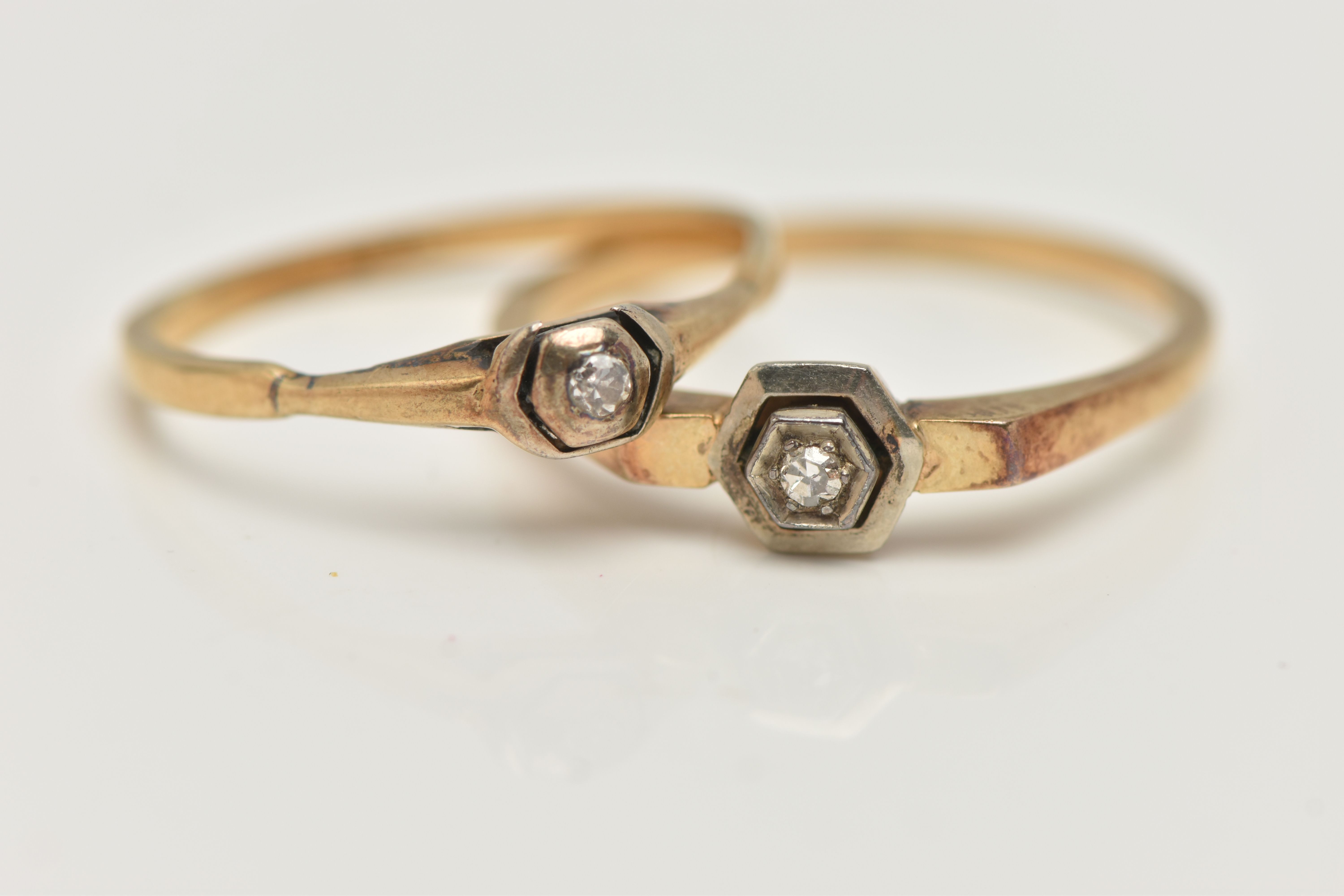 TWO DIAMOND RINGS, both set with single cut diamonds, with outer hexagonal settings, one stamped