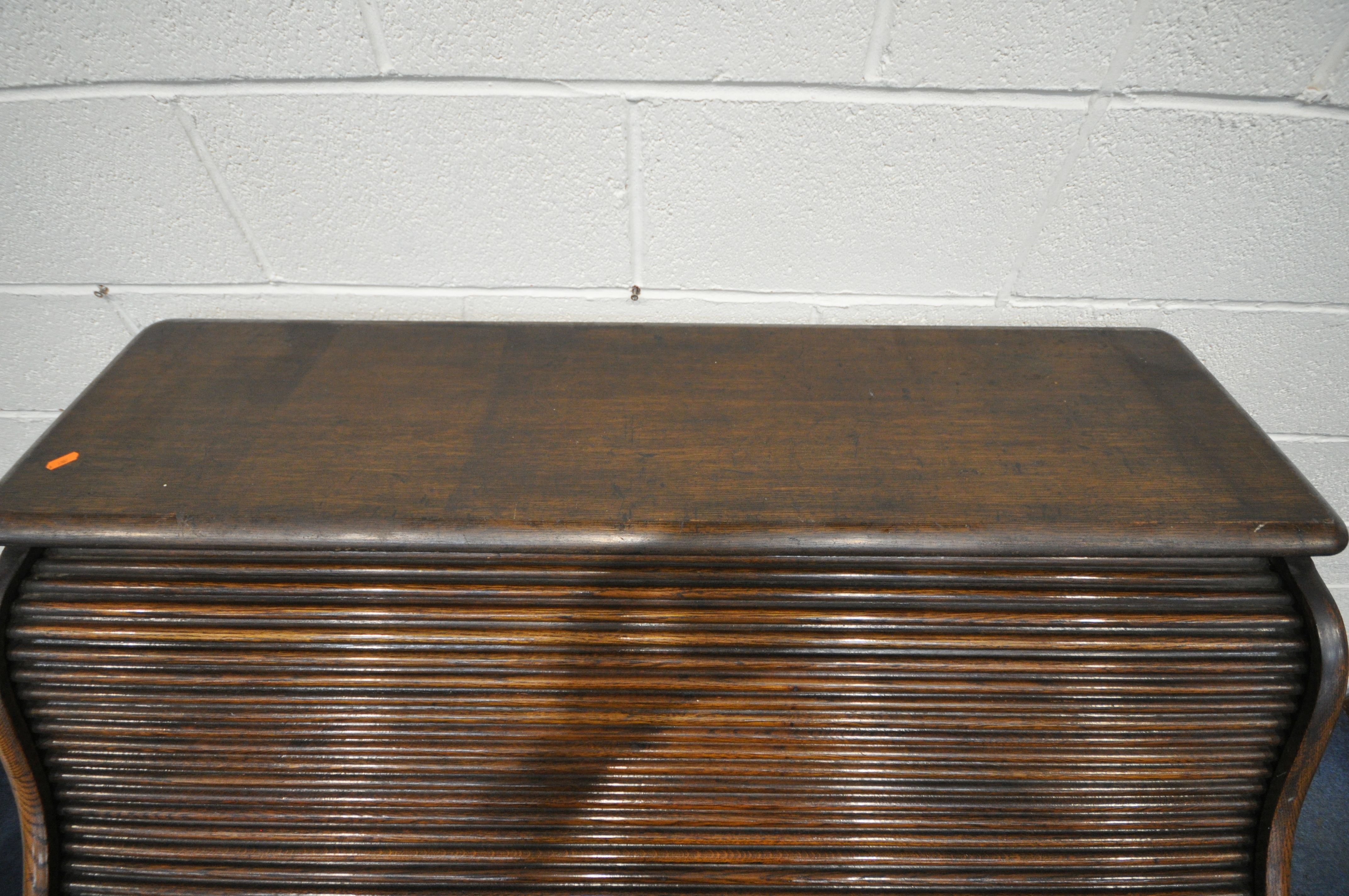 AN EARLY 20TH CENTURY OAK ROLL TOP DESK, enclosing a fitted interior, on two pedestals, each with - Image 3 of 8