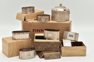 SEVEN SILVER NAPKIN RINGS AND AN INDIAN TRINKET BOX, to include a set of four engine turned napkin