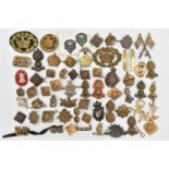 A BAG OF ASSORTED MILITARY CAP BADGES AND PINS, various designs, some with enamel detail, various