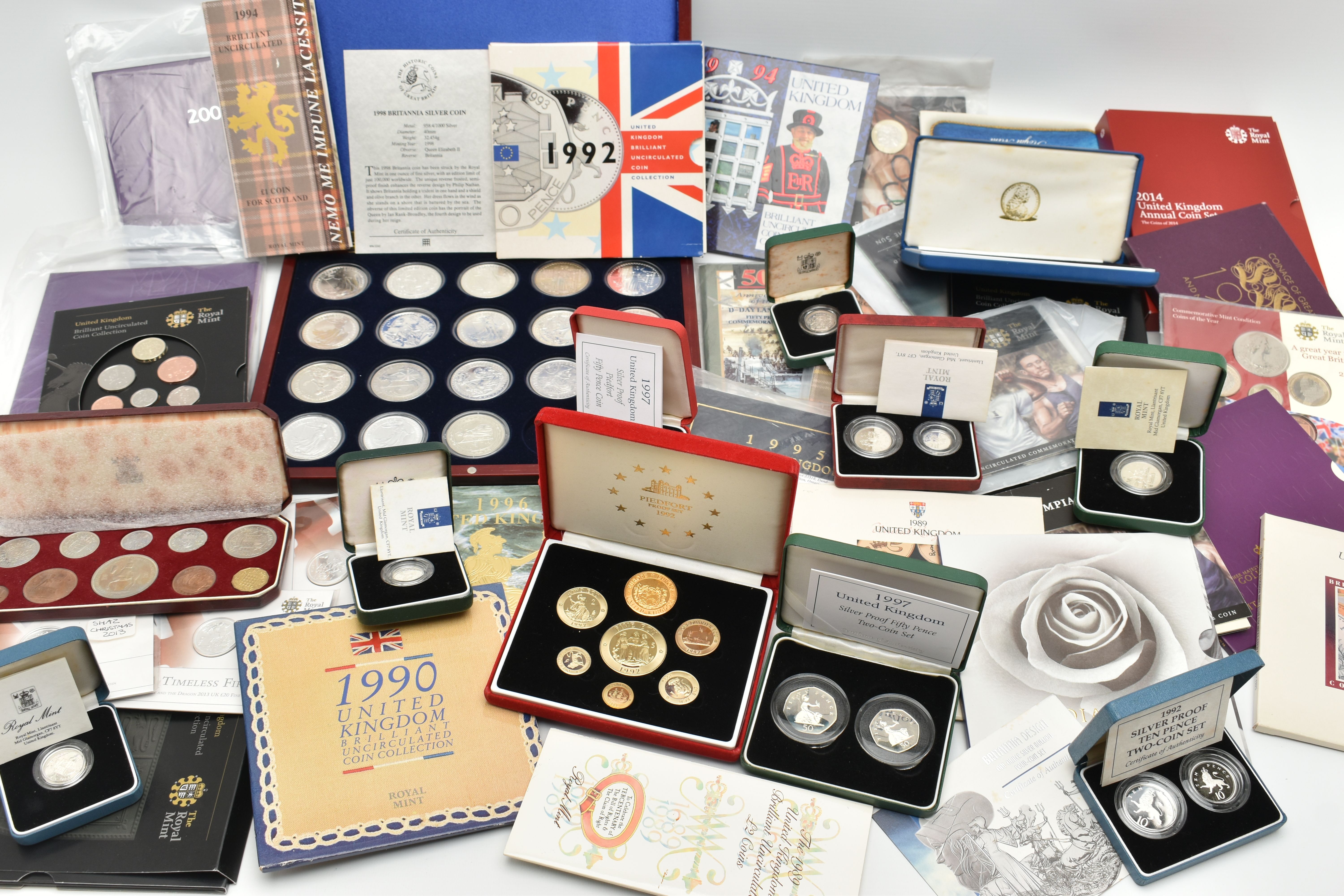 A RED BOX OF ROYAL MINT SILVER AND SILVER PROOF COINS TO INCLUDE 17 BRITANNIA COINS (Some with