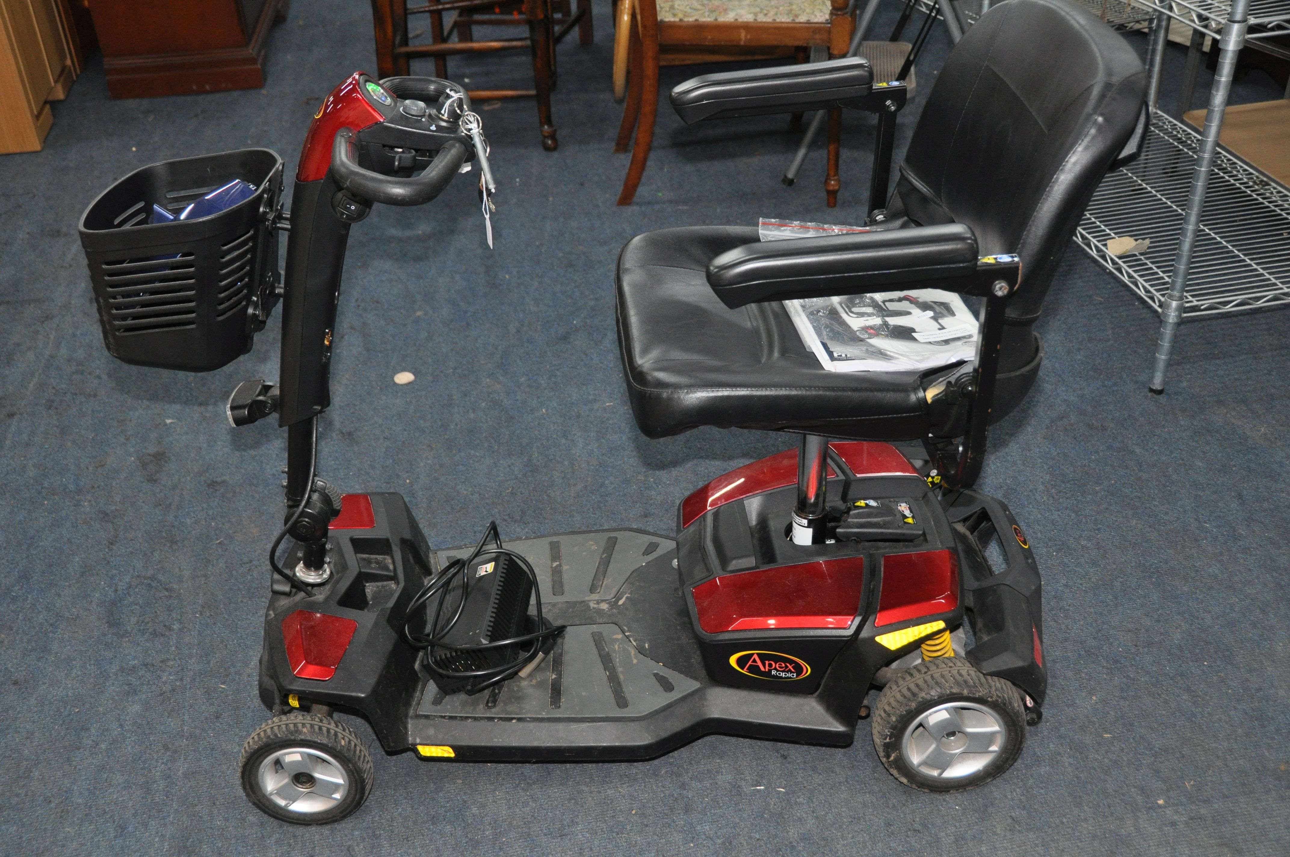 A GO GO ELITE TRAVELLER LX MOBILITY SCOOTER with charger front basket and spare colour change panels