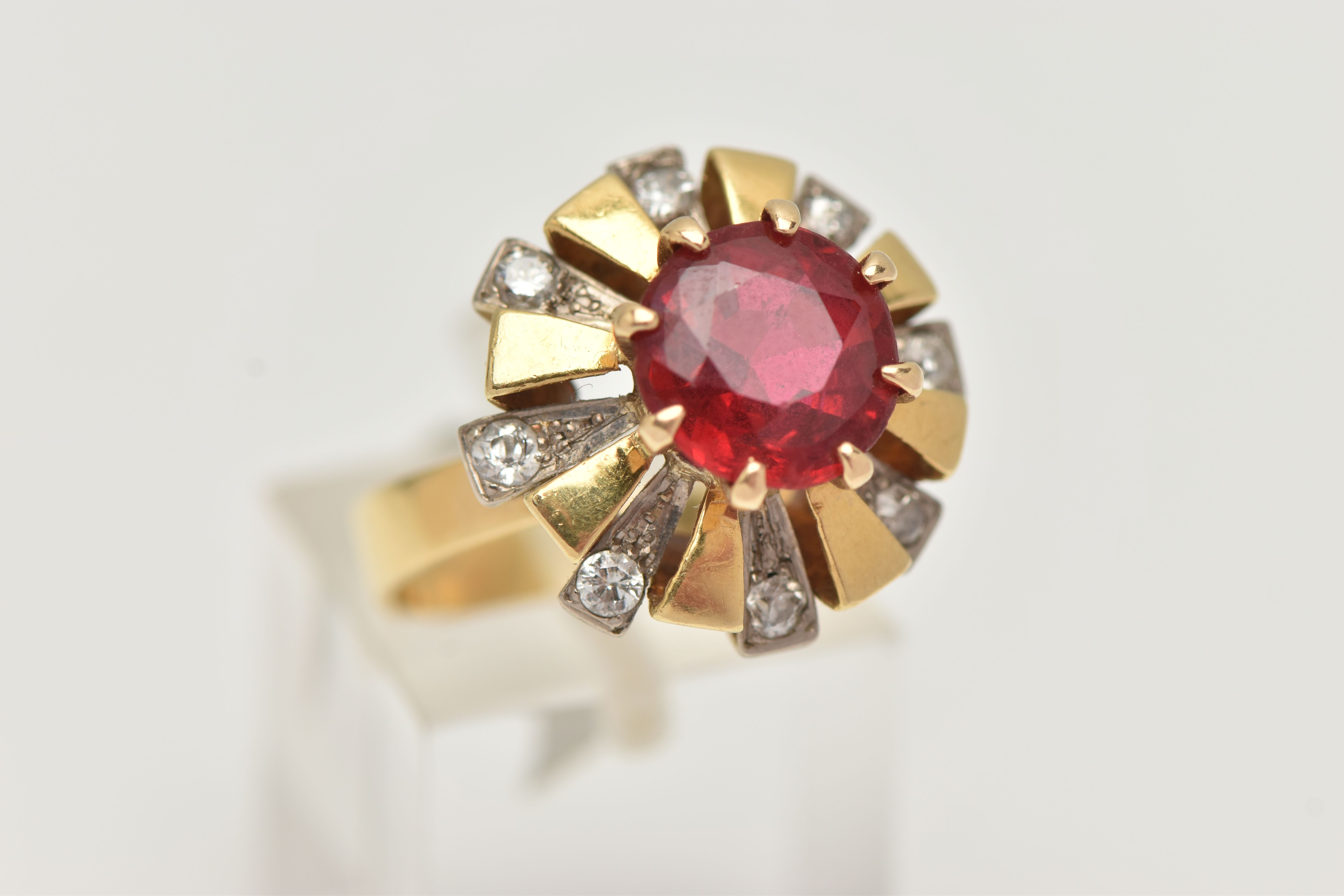 A YELLOW METAL GEM SET DRESS RING, centering on a large circular cut garnet topped red paste - Image 4 of 5