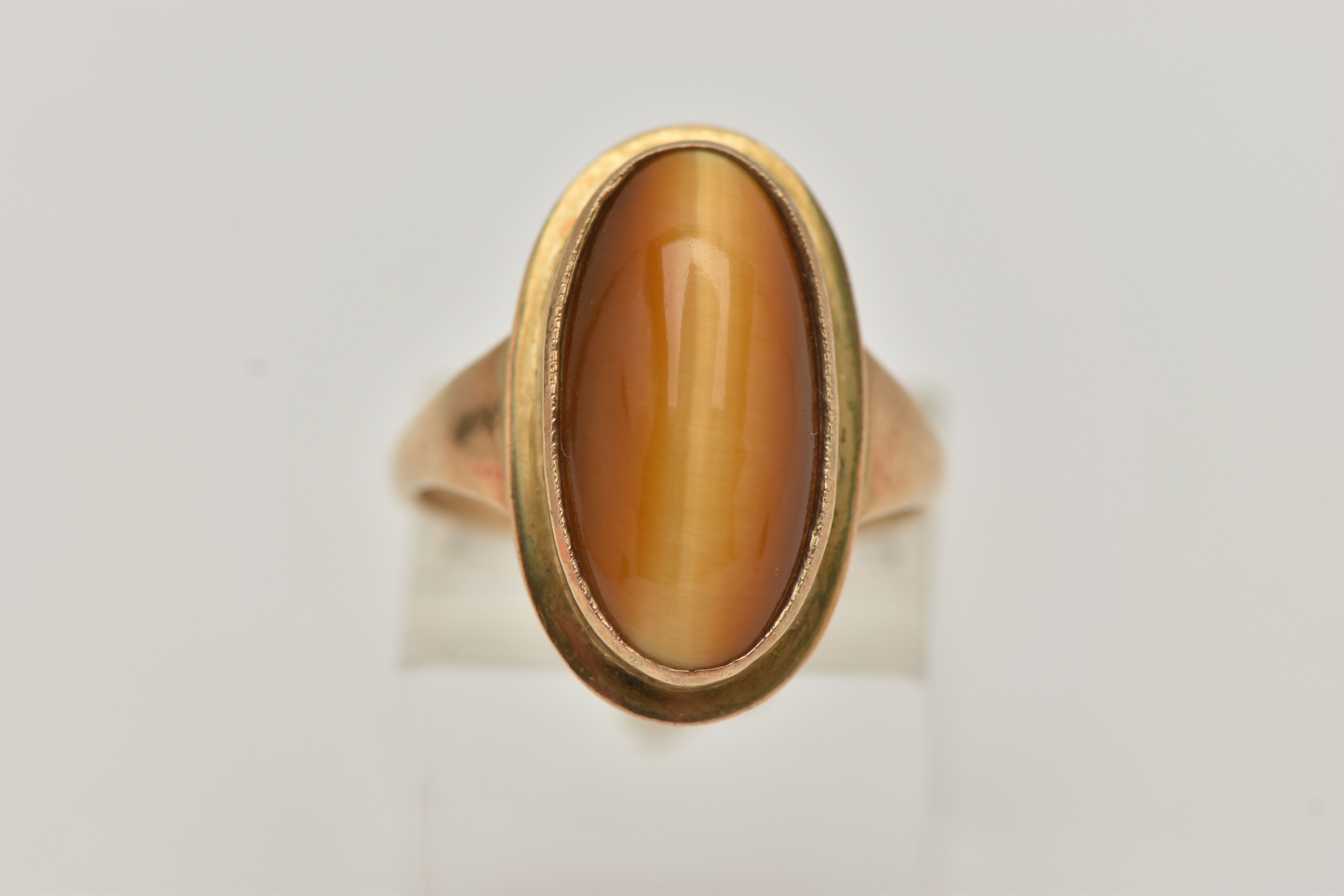 A 9CT GOLD DRESS RING, an elongated oval cabochon tigers eye, collet set in yellow gold, leading - Image 5 of 5