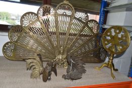 A BRASS PEACOCK FIRESCREEN, approximate height 62cm, together with a small brass tilt top table,