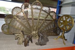 A BRASS PEACOCK FIRESCREEN, approximate height 62cm, together with a small brass tilt top table,