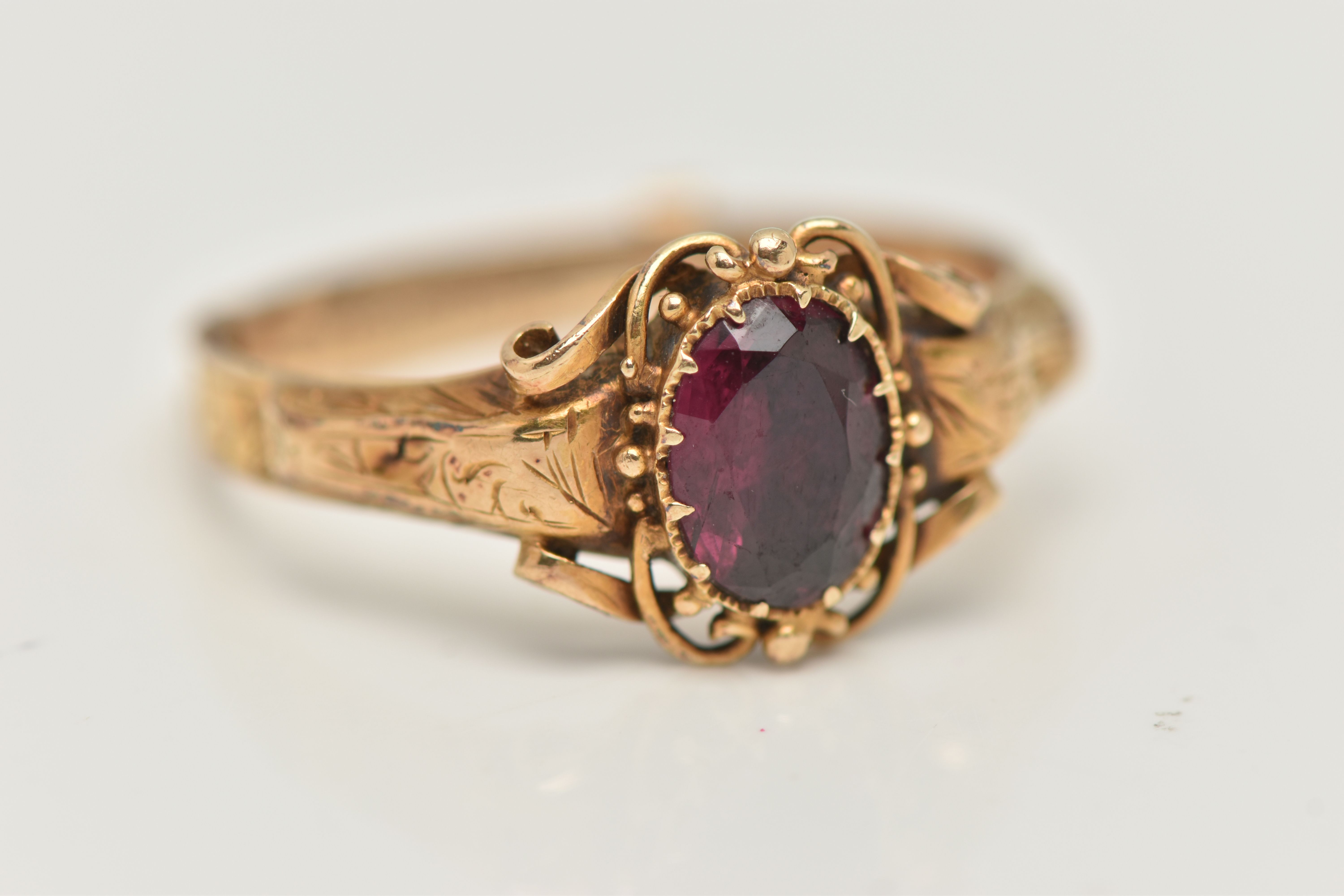 A VICTORIAN YELLOW METAL GARNET RING, centering on an oval cut garnet, claw set, the reverse of - Image 4 of 4