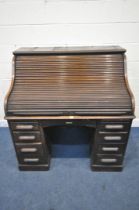 AN EARLY 20TH CENTURY OAK ROLL TOP DESK, enclosing a fitted interior, on two pedestals, each with