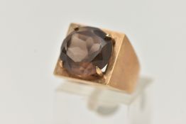 A 9CT GOLD DRESS RING, a circular cut smoky quartz, four prong set in yellow gold, set in a square