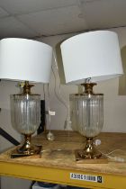 TWO MODERN TABLE LAMPS, with glass bodies and off white shades, height to top of fitting