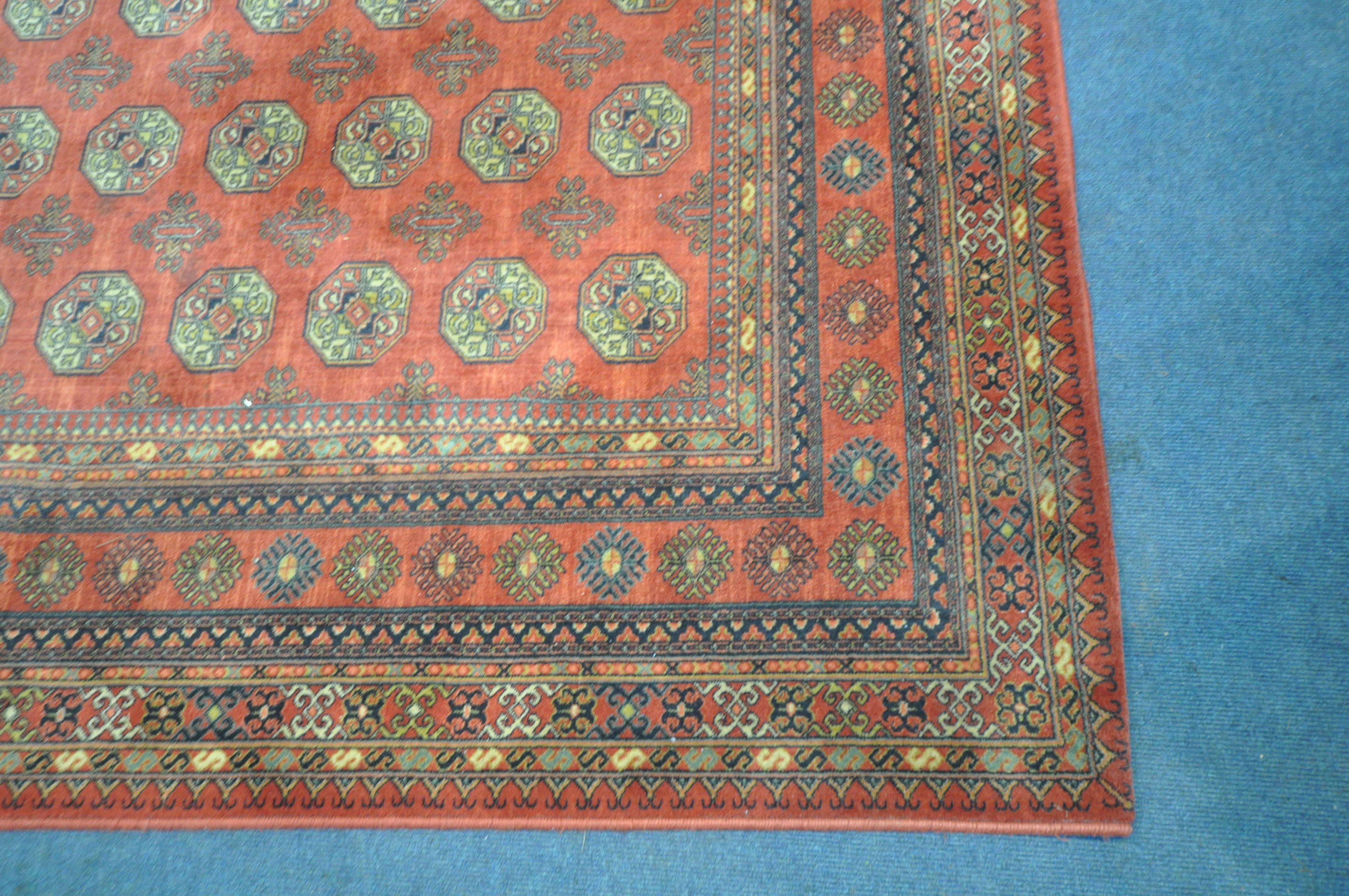 A RED GROUND TABRIZ WOOLLEN RUG, with forty eight central medallions, surrounded by a multi-strap - Image 2 of 5