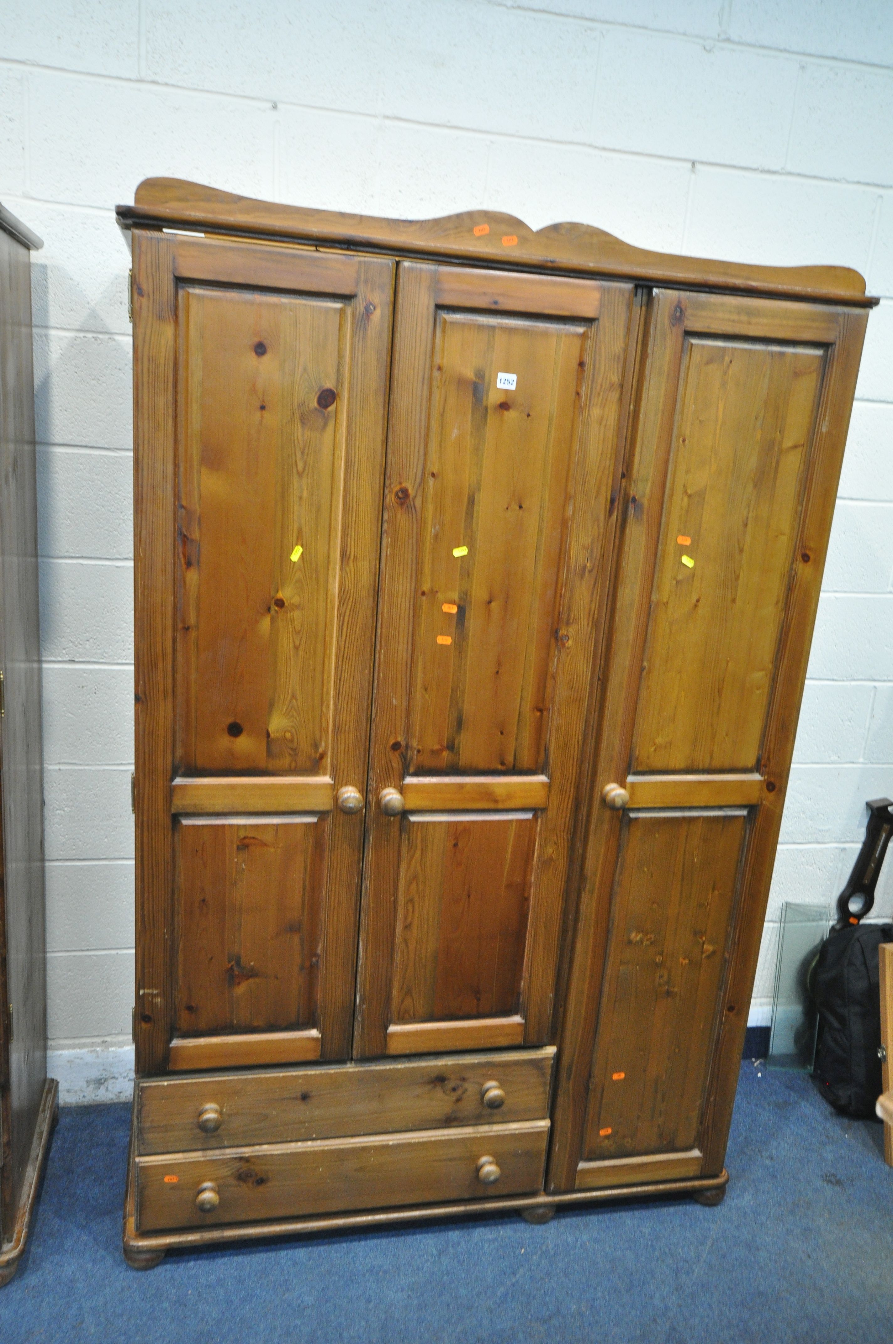 A MODERN PINE TRIPLE DOOR WARDROBE, with two drawers, width 129cm x depth 54cm x height 196cm, along - Image 2 of 3