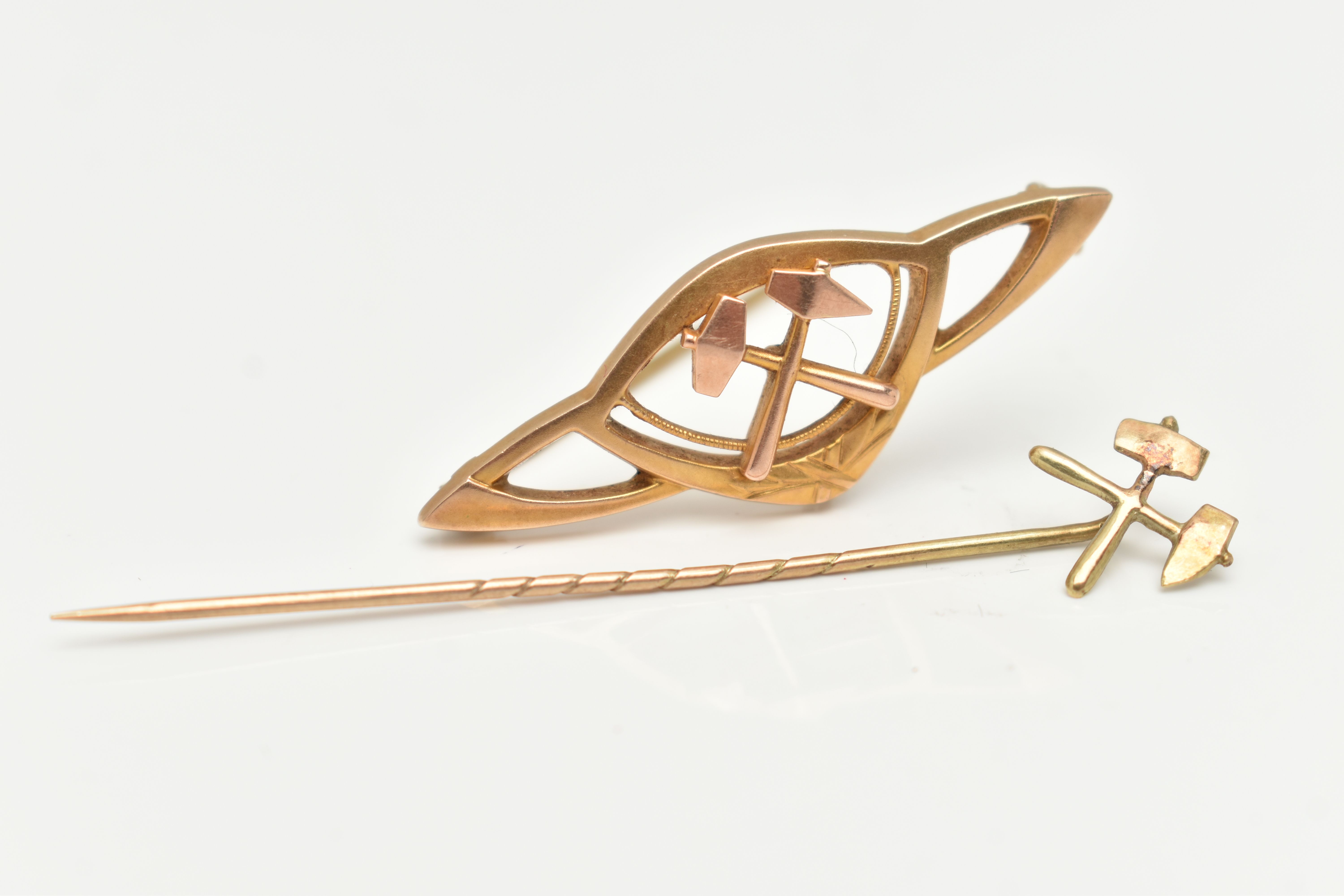 A STICKPIN AND A BROOCH, both with a crossed pickaxe and hammer motif, length 60mm, the brooch of