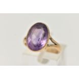 A YELLOW METAL AMETHYST RING, large oval cut amethyst, measuring approximately length 15.2mm x width