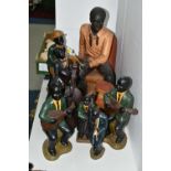 A GROUP OF EIGHT CERAMIC JAZZ MUSICIANS, comprising bass player, trumpet player, two guitarists (one