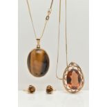 A TIGERS EYE PENDANT NECKLACE AND EARRING SET AND A SMOKY QUARTZ PENDANT, a large oval tigers eye