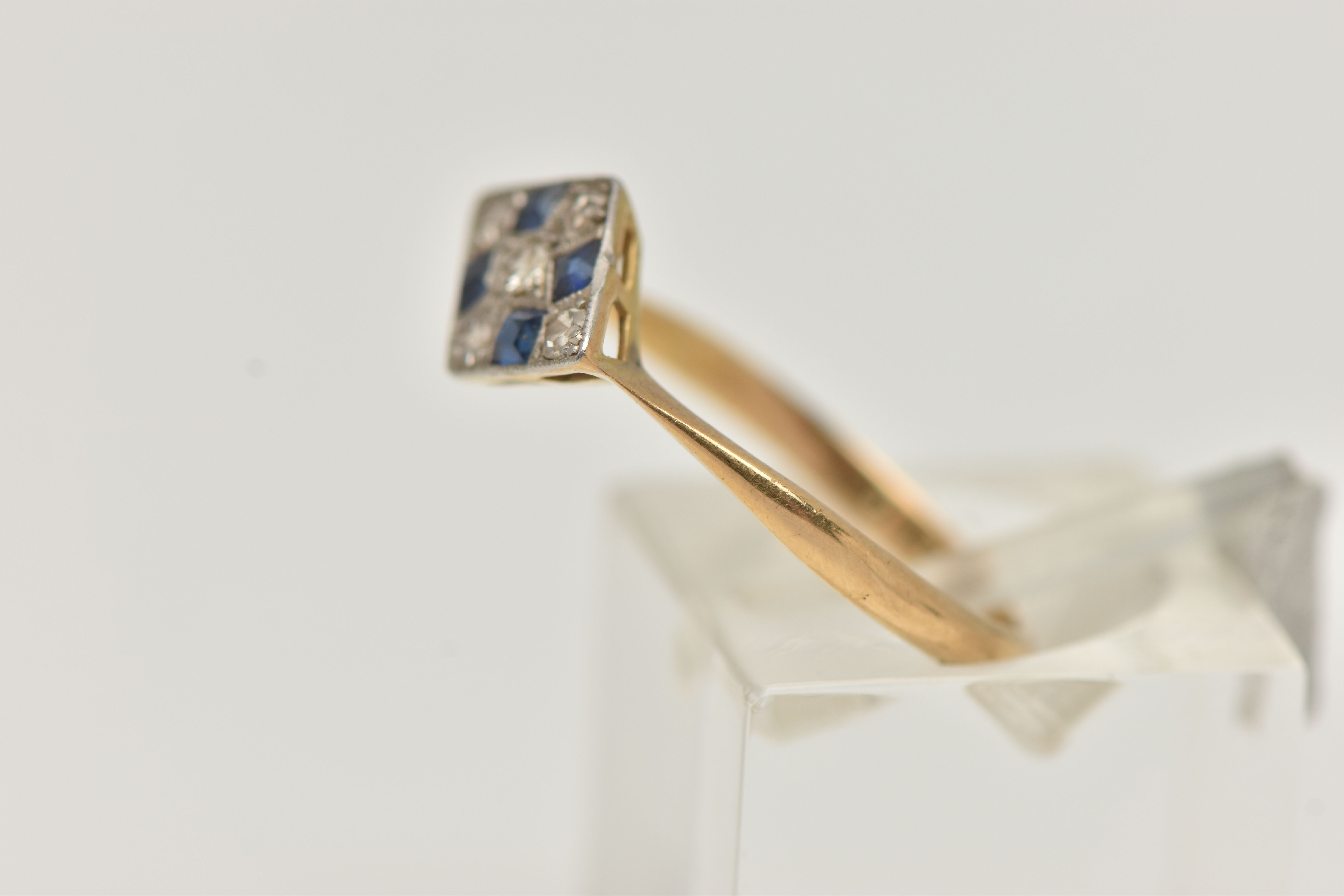 A LATE ART DECO SAPPHIRE AND DIAMOND RING, a rhombus form white metal mount, set with four square - Image 2 of 4
