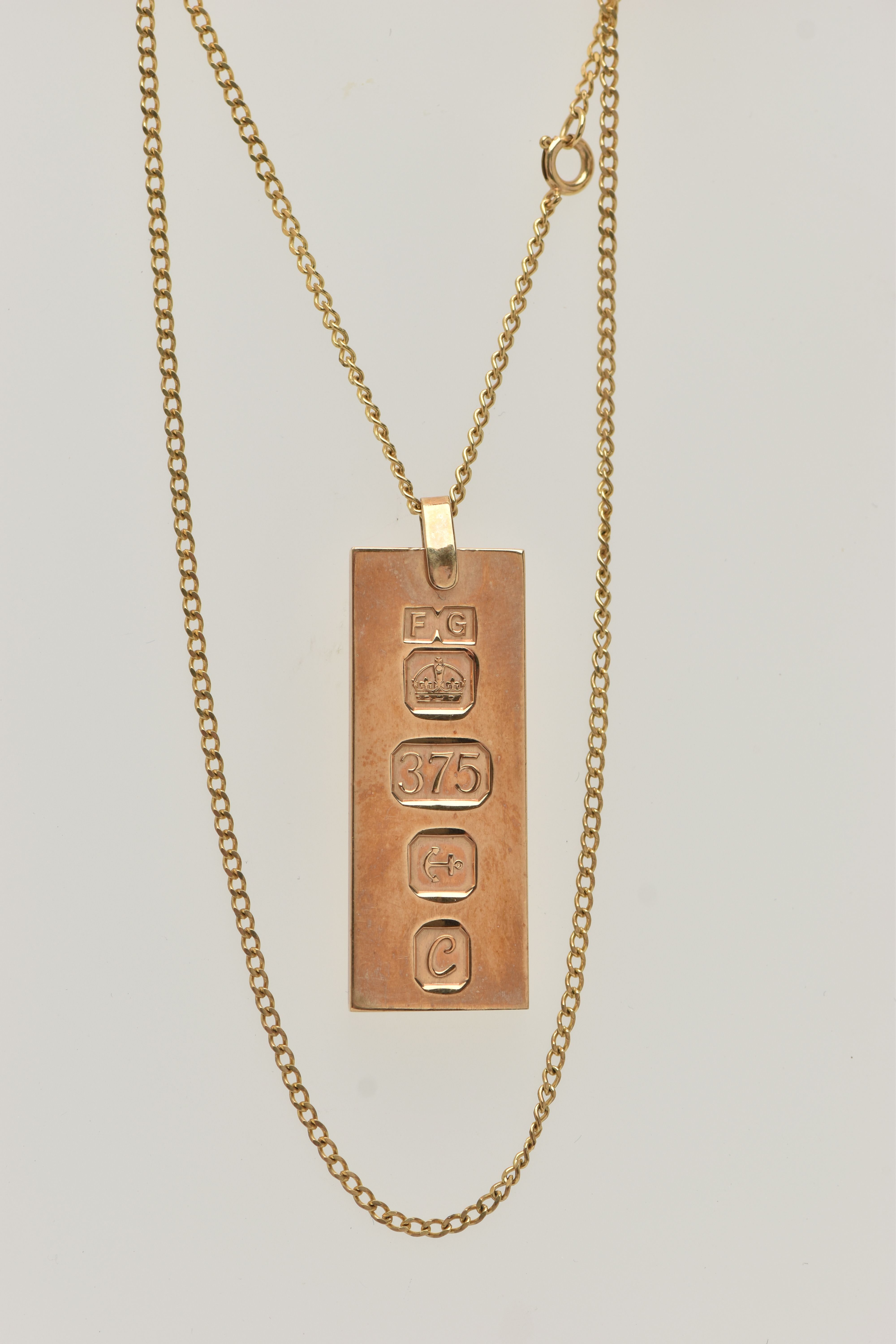 A 9CT GOLD INGOT PENDANT AND CHAIN, the rectangular pendant with large hallmark for Birmingham 1977,