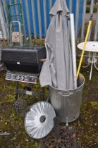 A COLLECTION OF GARDEN TOOLS AND A BARBECUE including a galvanised fire bin, a parasol with stand,